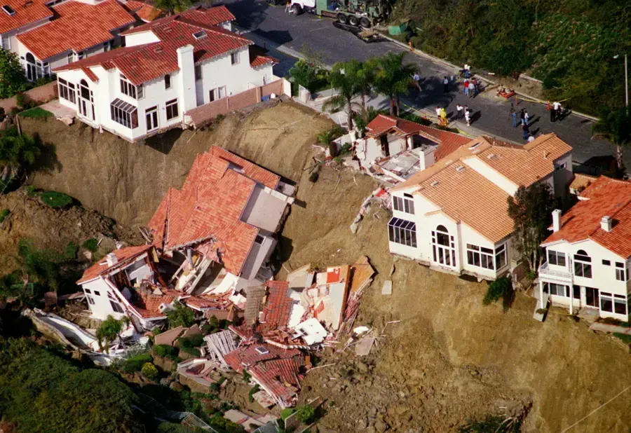Aerial view of hillside homes broken apart by a landslide after heavy winter rain in South Orange County