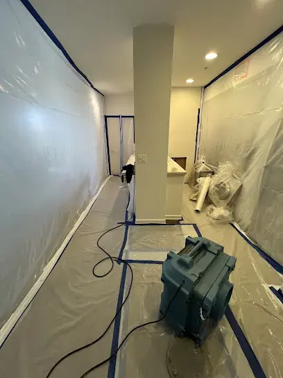 Interior hallway sealed with plastic containment and a dehumidifier, condo water damage dry-out in Laguna Niguel